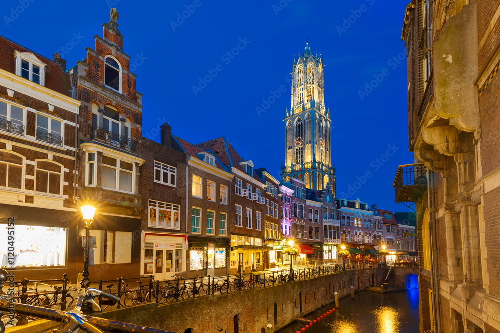 Dom Tower, bridge and canal Oudegracht in the night colorful illuminations in the blue hour, Utrecht, Netherlands