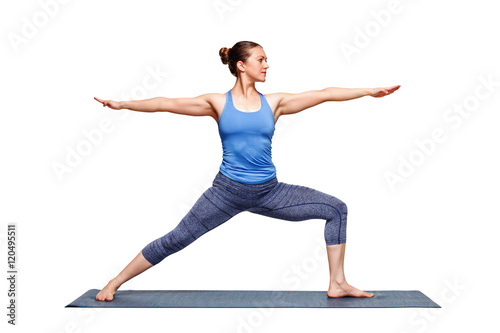 Sporty fit woman practices yoga asana utthita Virabhadras photo