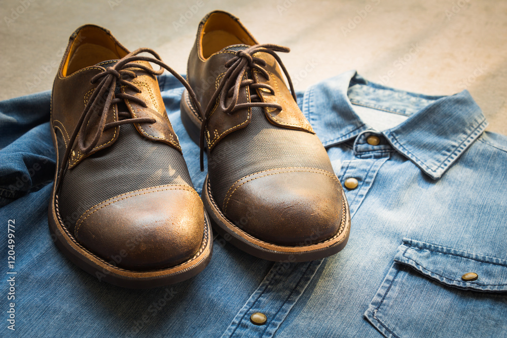 Men's casual outfits with jeans shirt and brown shoes on gray background Men's casual outfits with jeans shirt and brown shoes on gray background