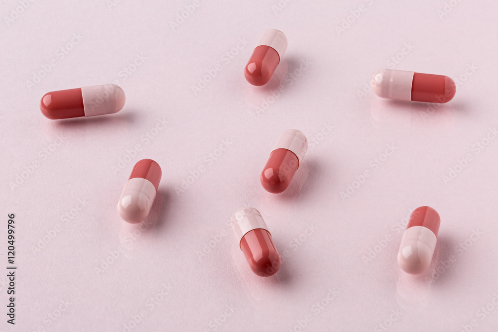 Drug brown capsules scattered on the table Drug brown capsules scattered on the table