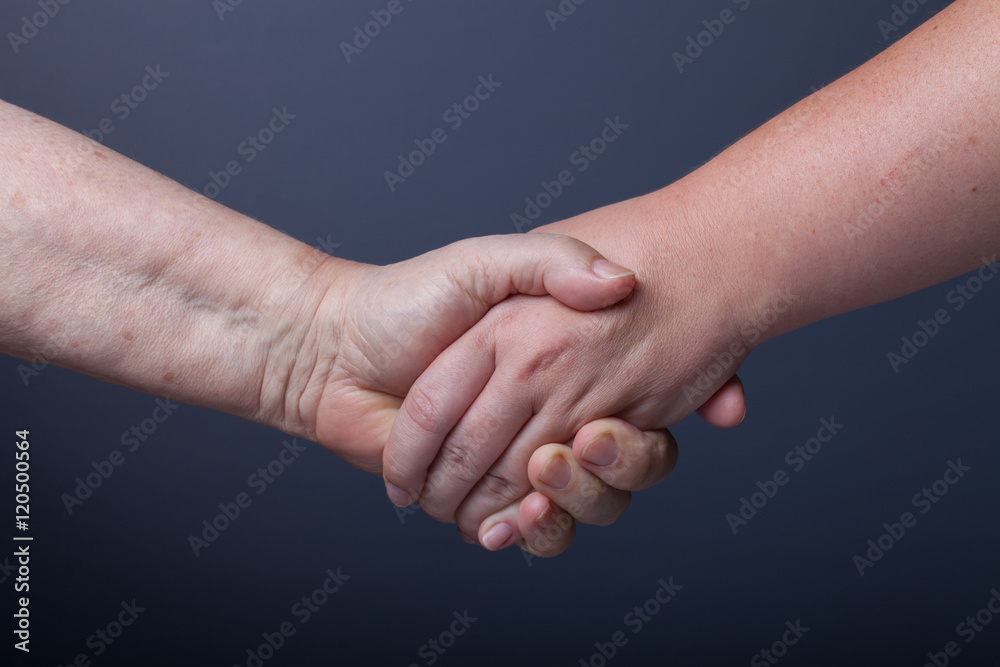 Hands of elderly and young women on black background Hands of elderly and young women on black background