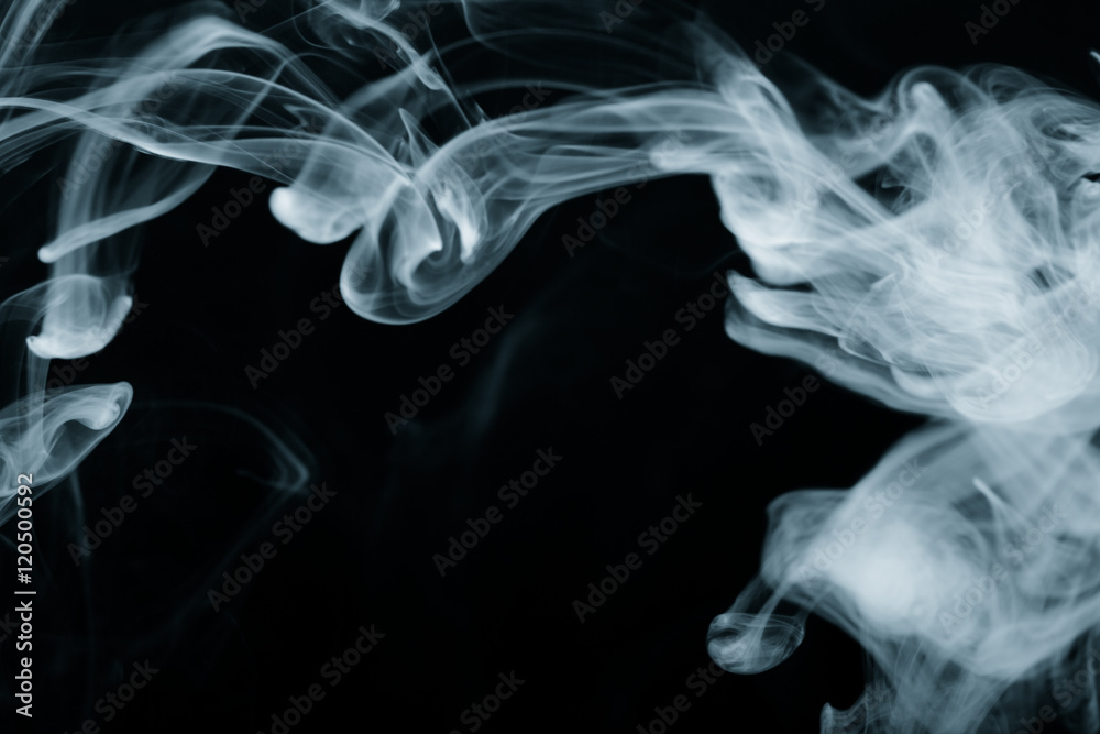 Fototapeta premium Cloud of smoke on black background. Selective focus. Toned
