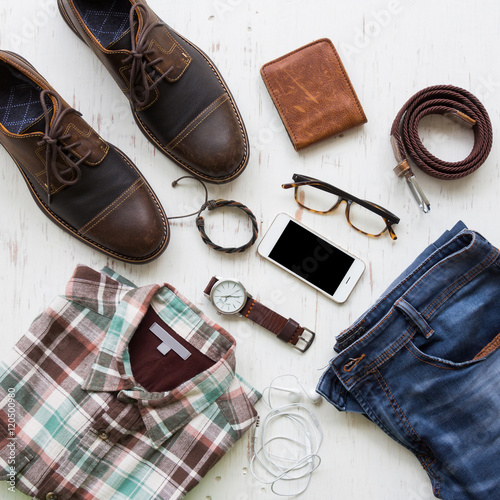 Men's casual outfits with man clothing and accessories on rustic wooden background, travel concept