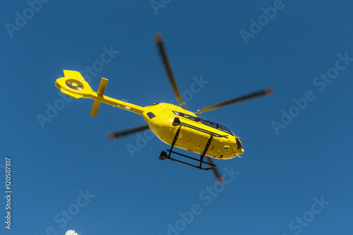  Medical rescue helicopter flying rescue injured climber on the Tre Cime. Italy, Dolomites