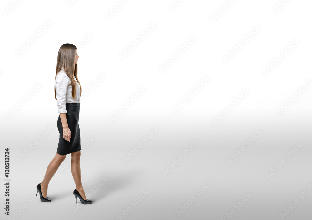 Cutout businesswoman in an office dress goes to side. Cutout businesswoman in an office dress goes to side.