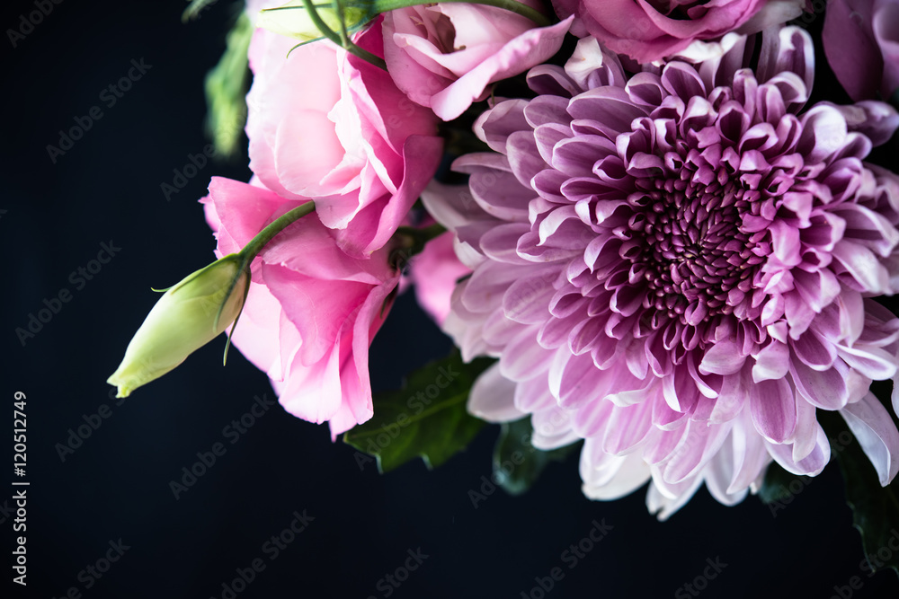 Fototapeta premium Bouquet of pink flowers closeup on black background
