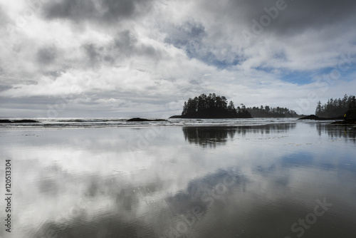 Reflection of clouds in water on beach, Pacific Rim National Par