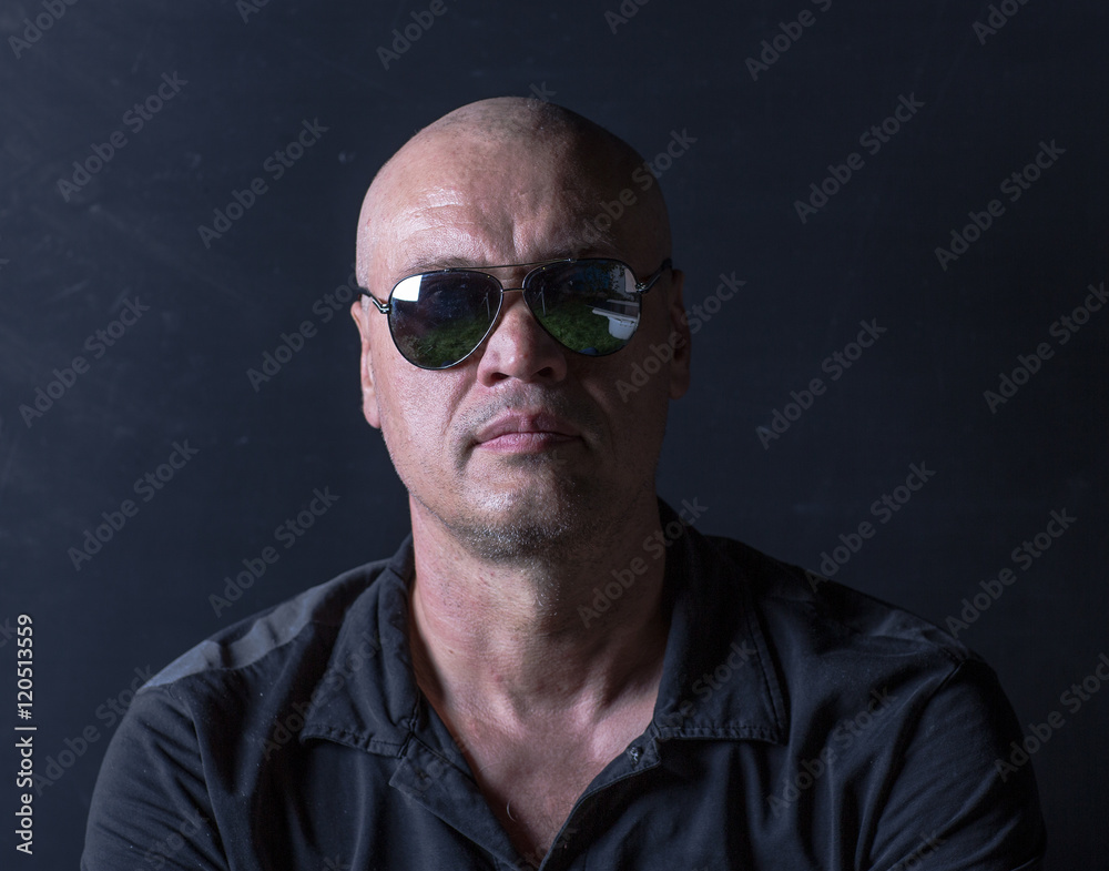 studio portrait of a bald man with glasses studio portrait of a bald man with glasses