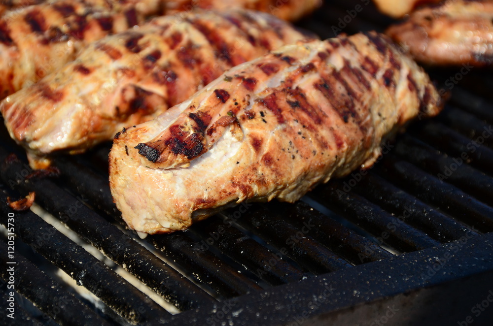 Barbecue chicken breast on a grill