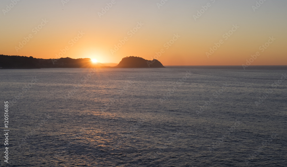 Sea and coast with the sun in the background. Sea and coast with the sun in the background.