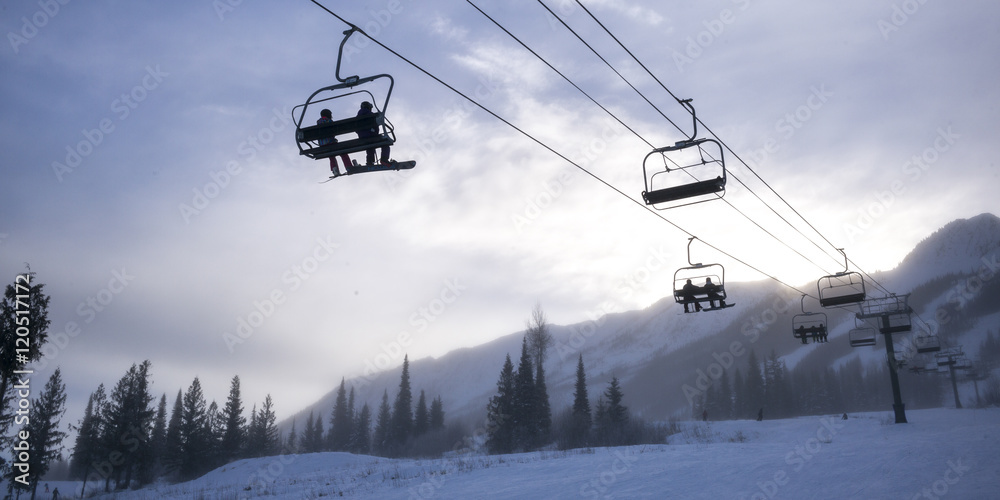 Tourists on ski lifts in valley,  Kicking Horse Mountain Resort,