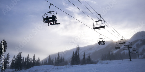 Tourists on ski lifts in valley, Kicking Horse Mountain Resort,