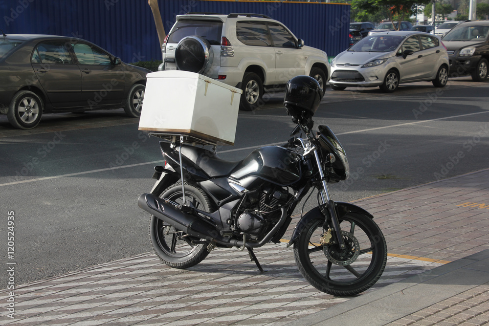 A typical food delivery bike in a warm tropical environment A typical food delivery bike in a warm tropical environment