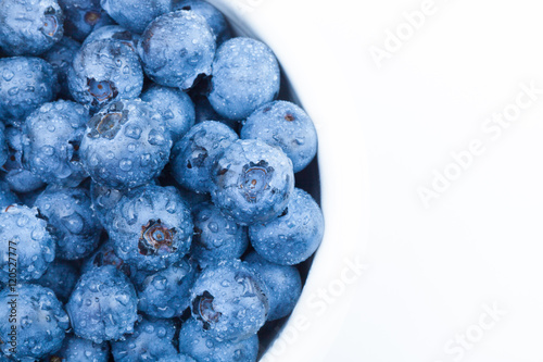 Bunch of fresh blueberries in white bowl - studio shot