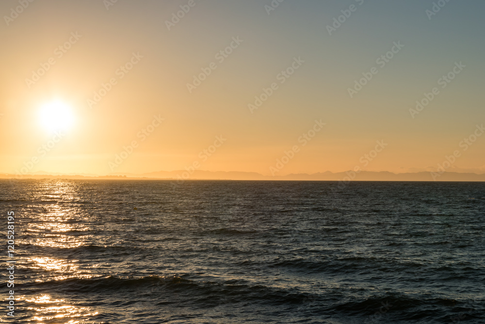 sun rising over mediterranean sea coast