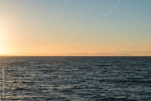 sun rising over mediterranean sea coast © lakkot