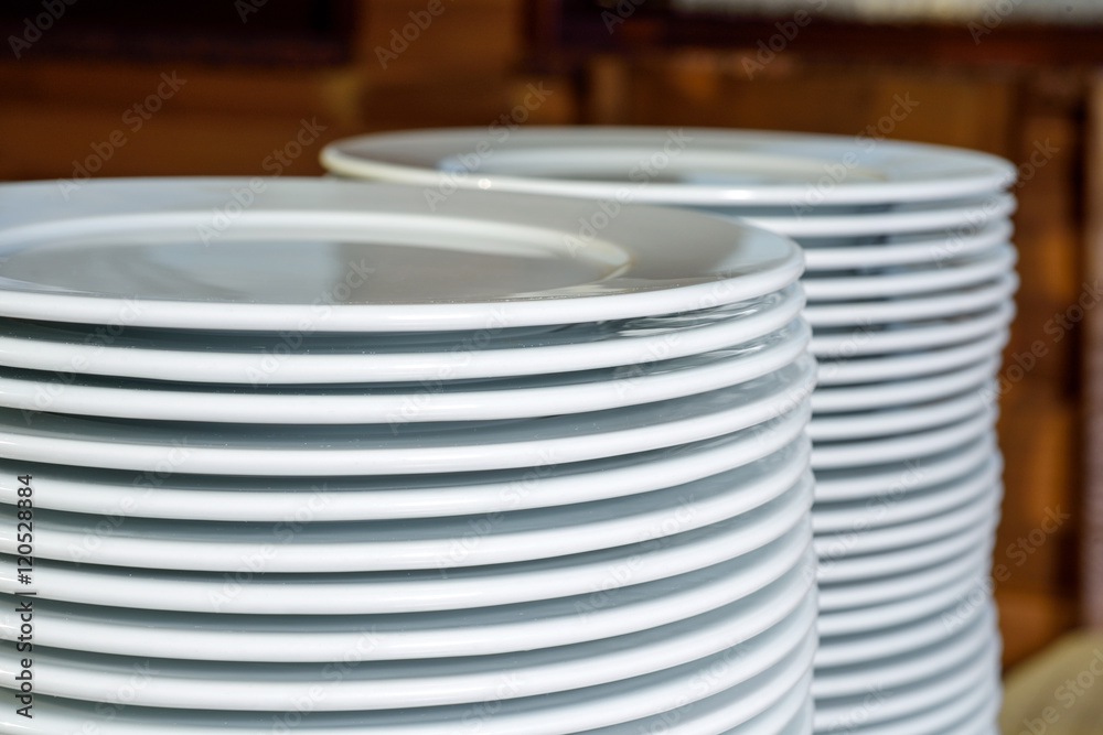 stack of white plates on the table stack of white plates on the table