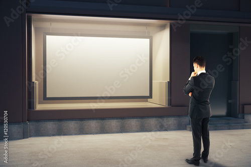 Pensive man looking at billboard