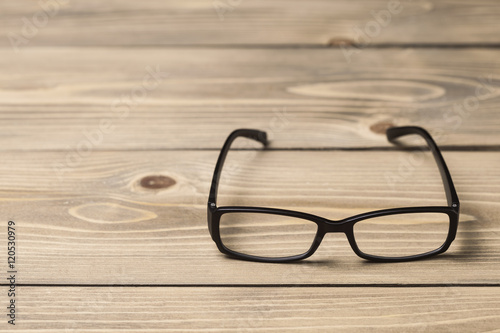 Black glasses on wood table