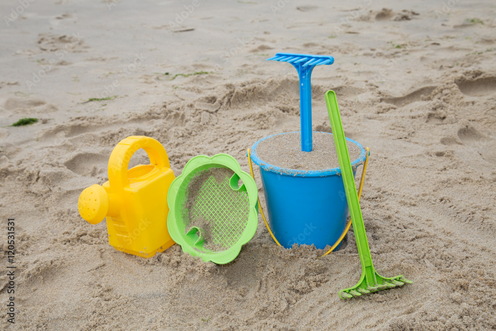 Child's toys on sandy beach, summer holidays concept Child's toys on sandy beach, summer holidays concept