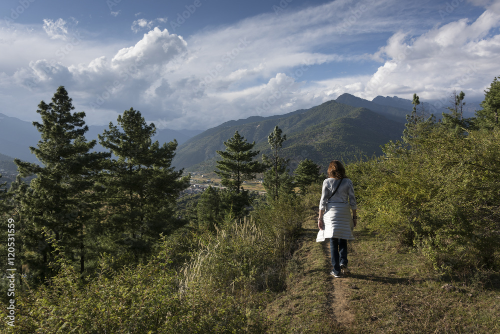 Woman hiking in the forest, Bhutan.