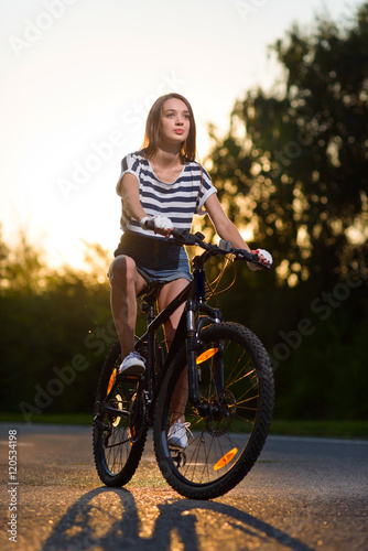 girl on a bicycle at sunset