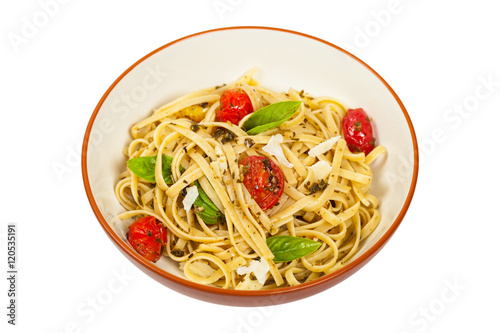 Pasta With Pesto and Roasted Tomatoes Isolated on White. Selective focus.