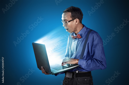Nerdy man with laptop use standing position