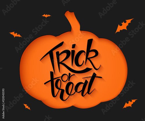 vector black paper sheet with clipped pumpkin silhouette, hand lettering halloween greetings quote - trick or treat - and bats