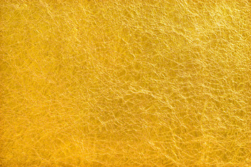 Shiny yellow leaf gold foil texture background