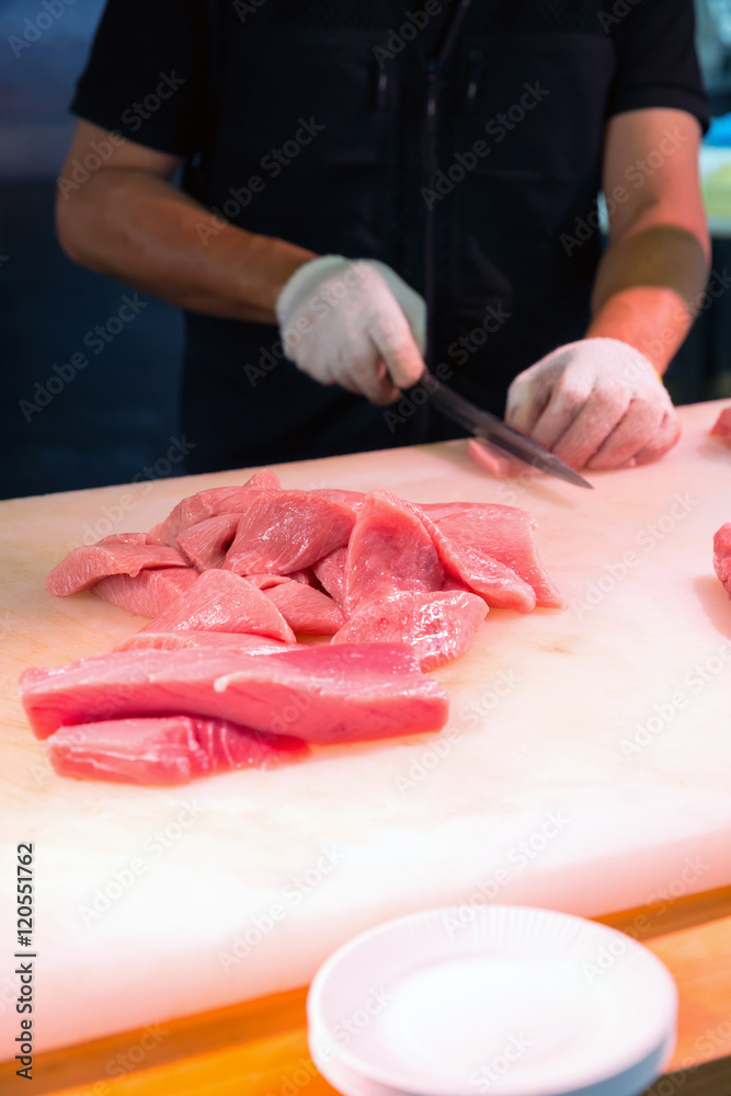 Chef cutting bluefin tuna in Kuromon Market