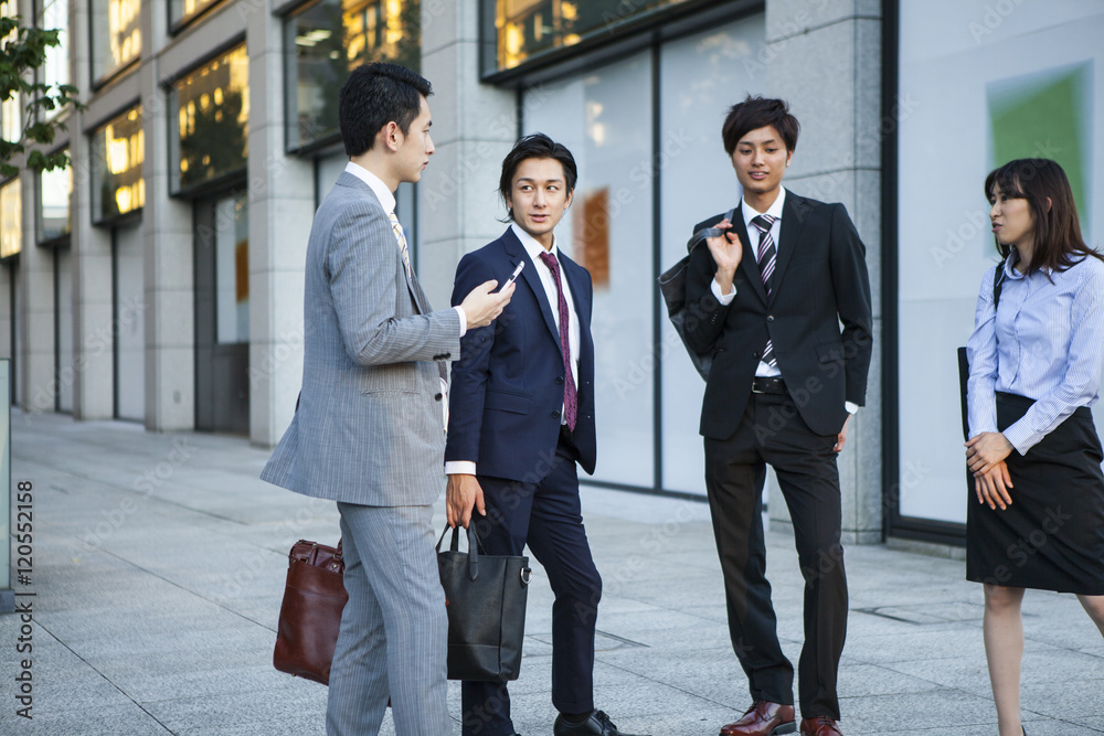Businessmen are talking in the office district Businessmen are talking in the office district
