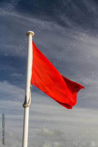 Red flag against blue sky