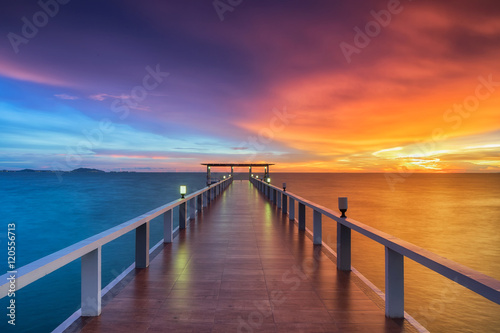 Wooden pier between sunset