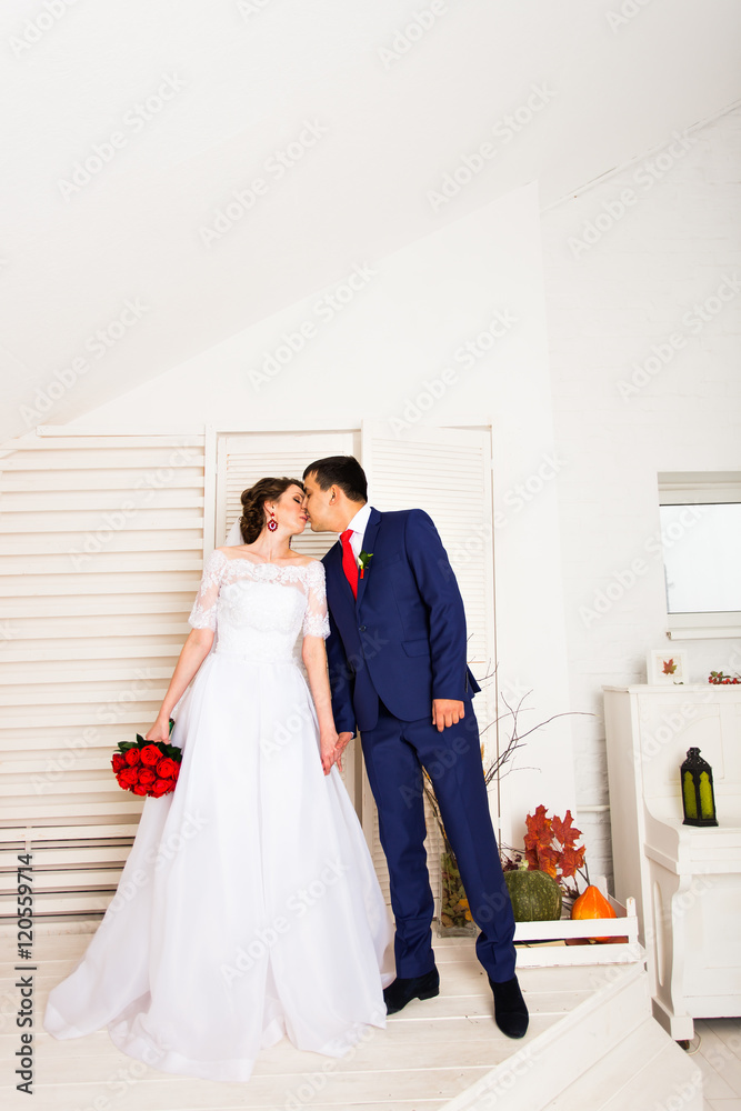 Portrait of Caucasian bride and Asian groom indoors Portrait of Caucasian bride and Asian groom indoors
