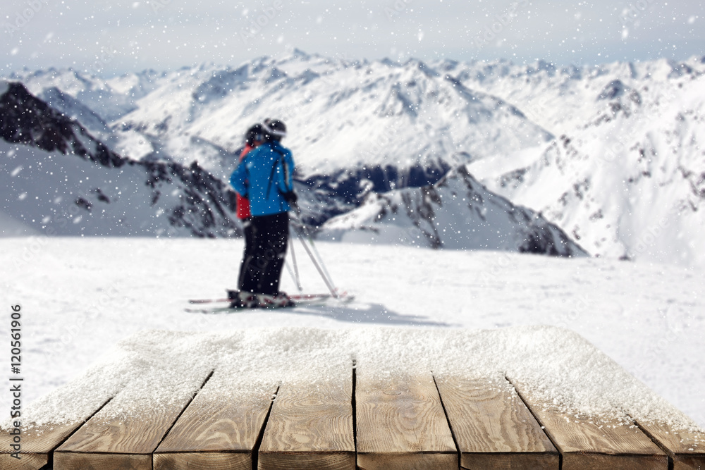 wooden table and skier in Alps mountains 