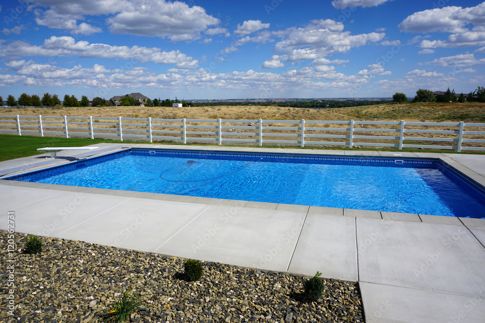 modern backyard swimming pool with fence and open space