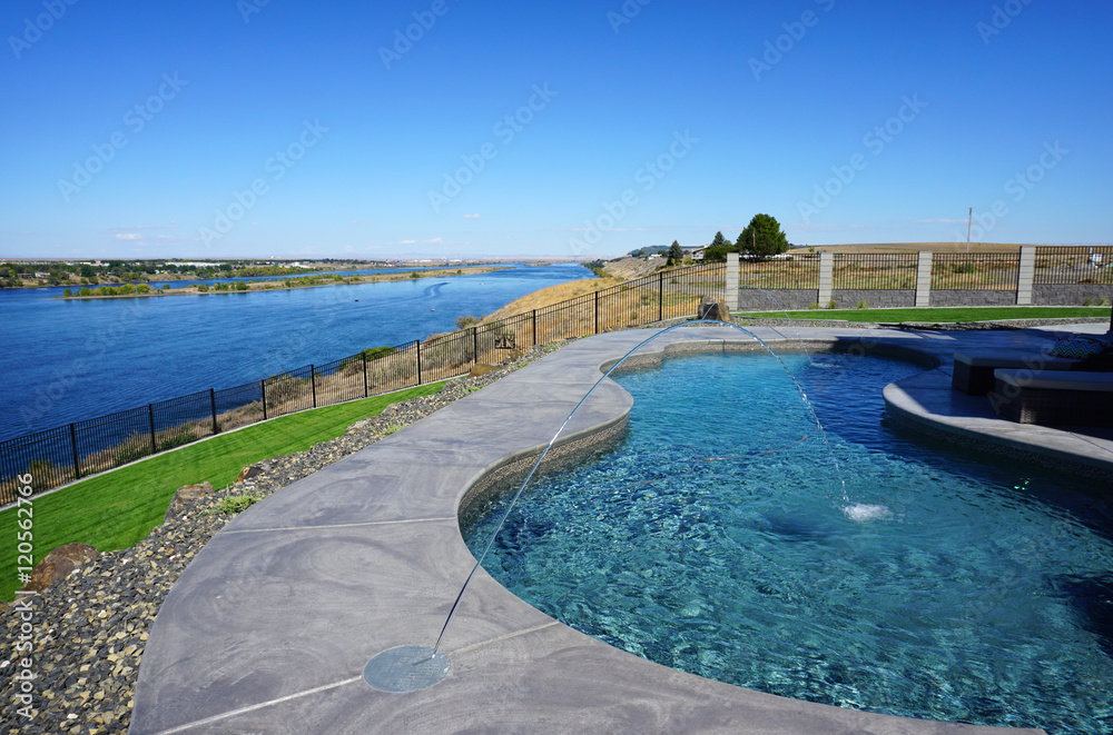 modern backyard swimming pool with view of river