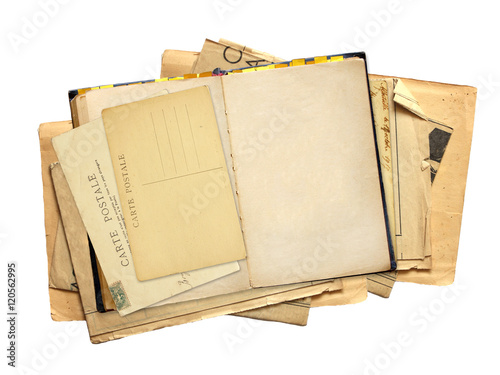 Old book with blank page and vintage post card