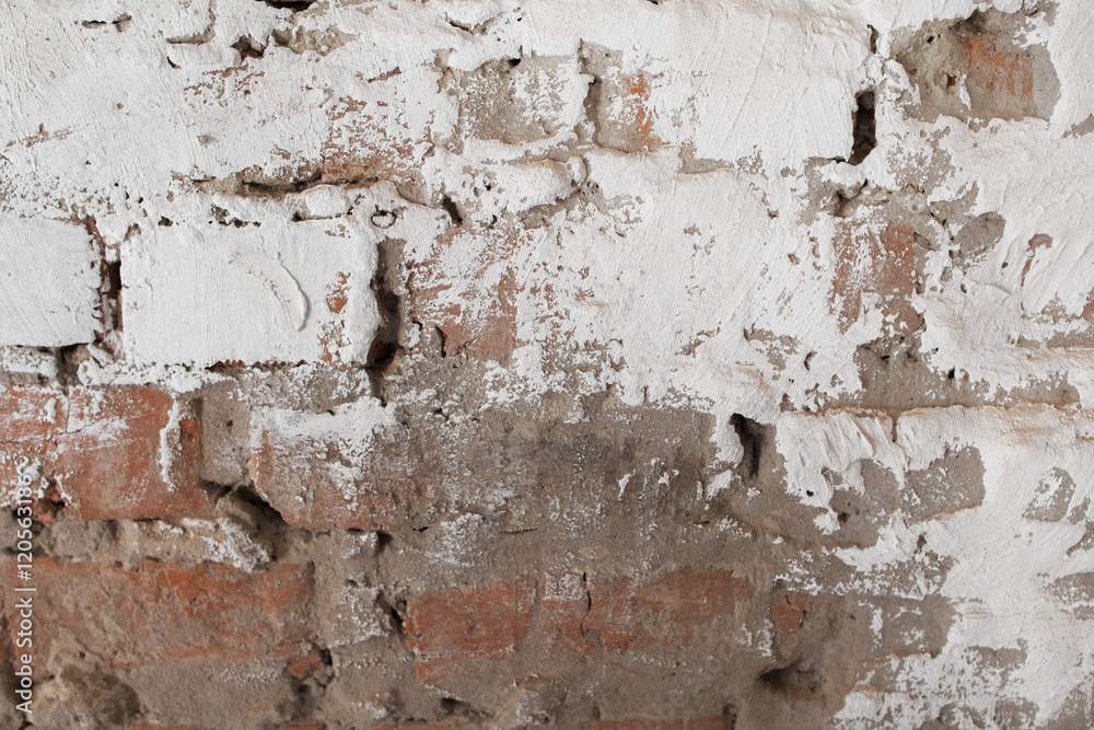 Obraz premium Old brick wall with plaster background. Fragment of outdoor side of damaged building with white and gray cement