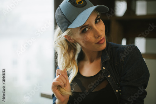 blond girl in a baseball cap.