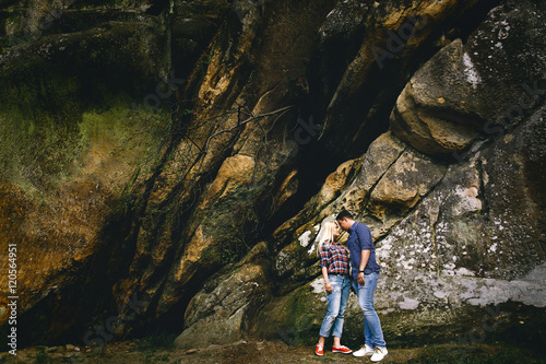 Young beautiful couple in jeans and shirts for a walk in the mou © IVASHstudio