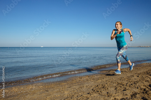 Woman running on the beach © skvalval