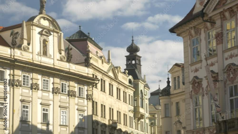 Pan across ornate buildings in old town square Prague as white clouds fly overhead Pan across ornate buildings in old town square Prague as white clouds fly overhead
