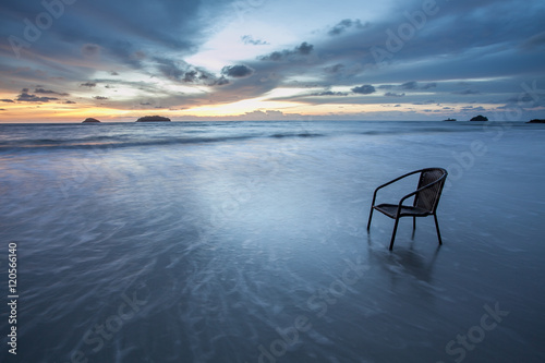 Chair in sea at sunset  long time of shutter speed