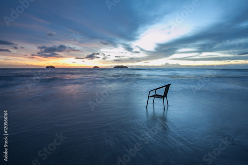 Chair in sea at sunset, long time of shutter speed © todja
