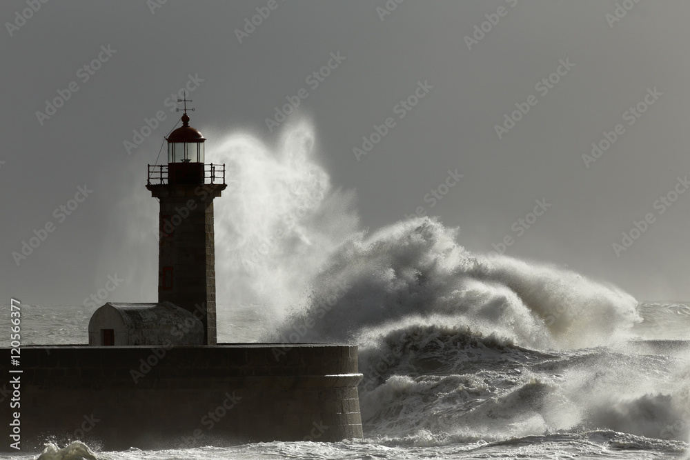 Stormy waves and spray over lighthouse