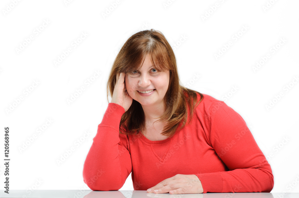 Portrait of charming smiling middle-aged woman sitting at a tabl Portrait of charming smiling middle-aged woman sitting at a tabl