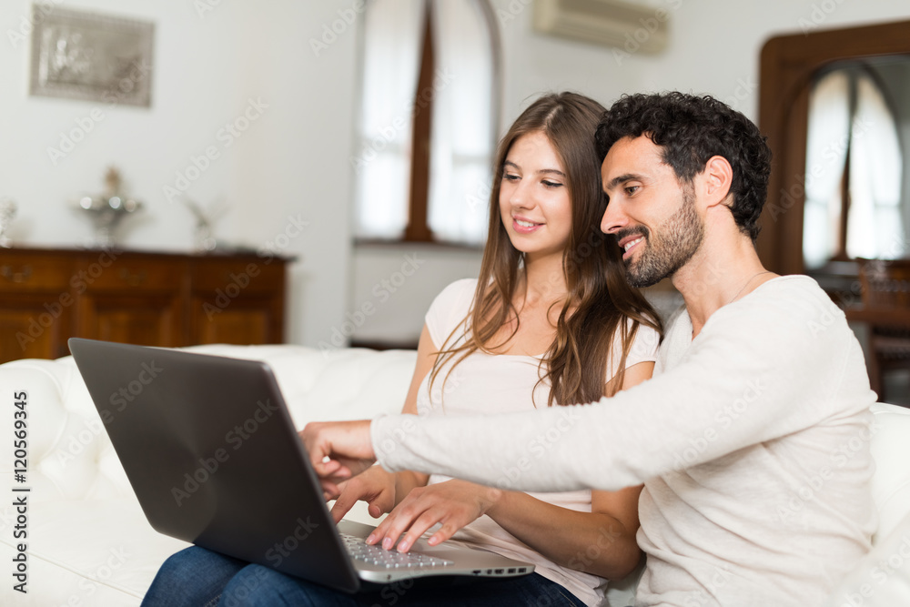 Couple using a laptop computer Couple using a laptop computer