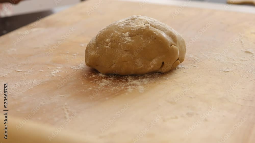 Using rolling pin to roll cookie dough Using rolling pin to roll cookie dough